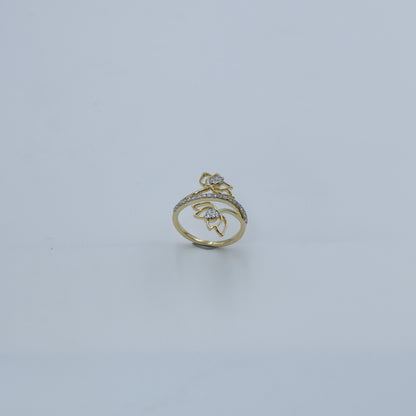 Gold ring with gemstones on a light gray background