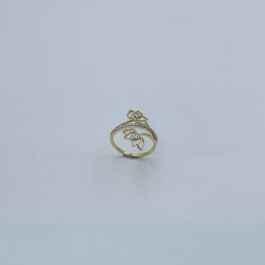 Gold ring with gemstones on a light gray background
