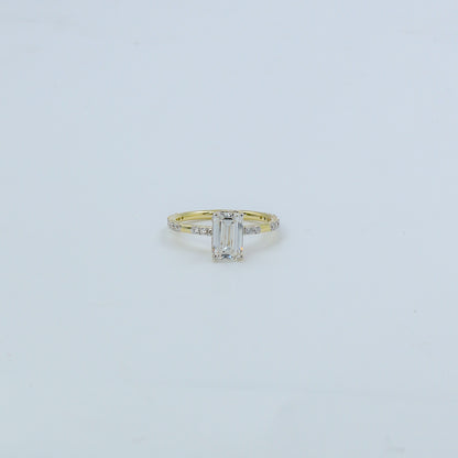 Gold ring with a diamond on a light gray background