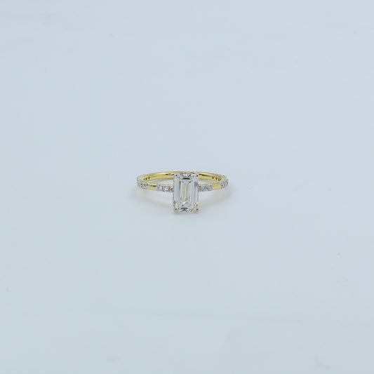 Gold ring with a diamond on a light gray background
