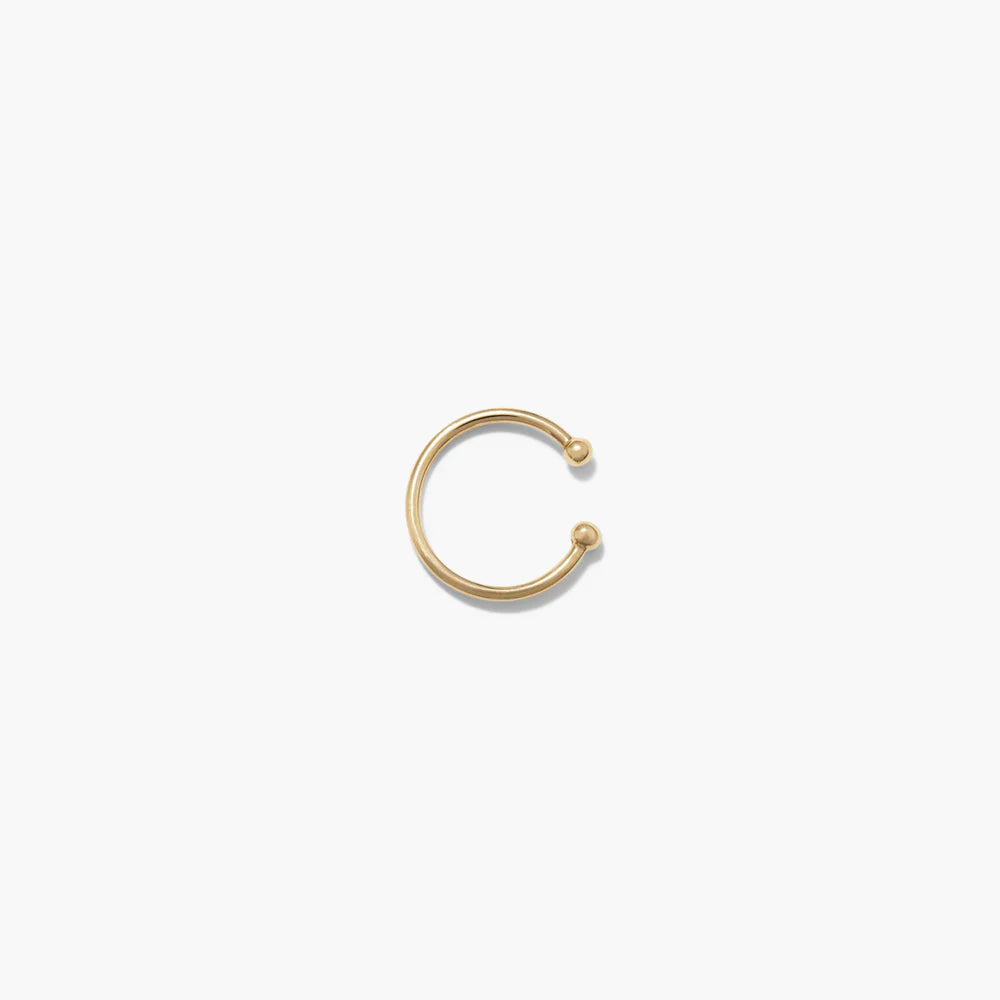 Gold nose ring on a white background