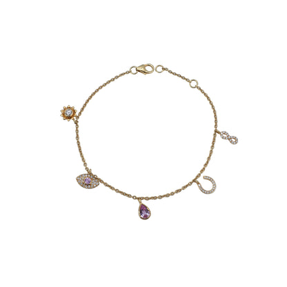 Gold bracelet with charms on a light blue background