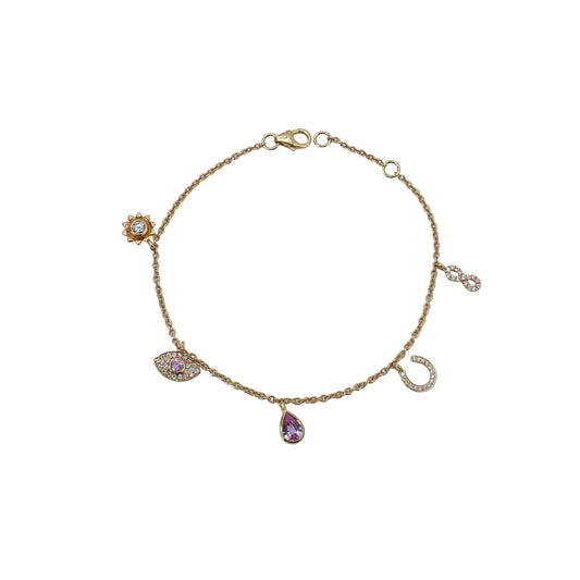 Gold bracelet with charms on a light blue background