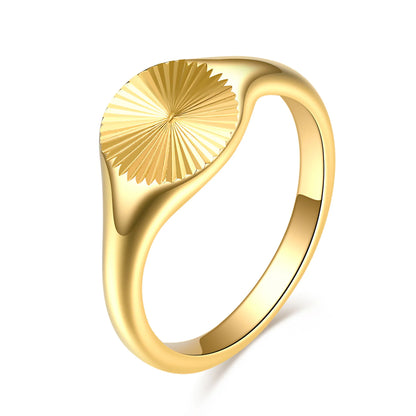 Gold ring with a textured design on a white background