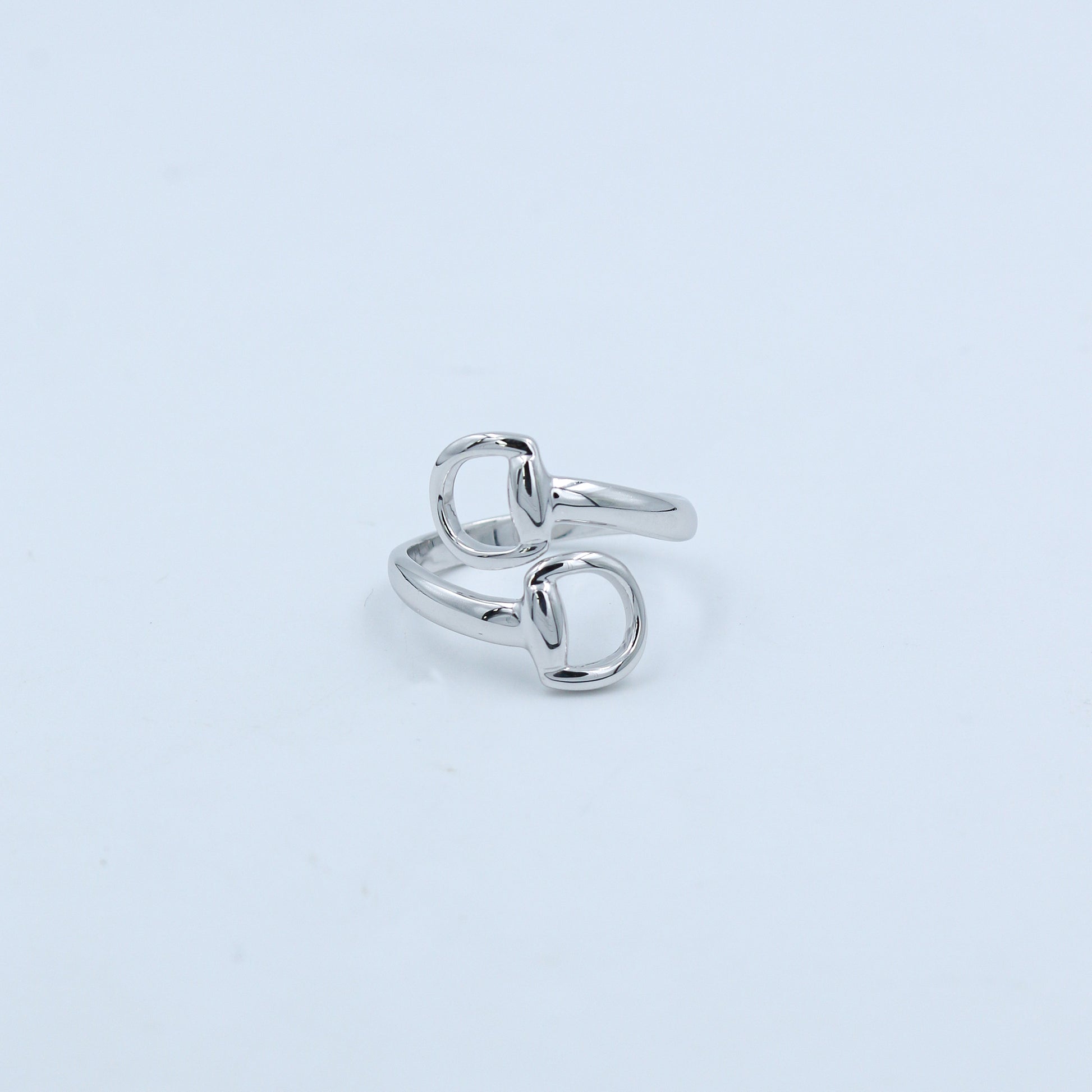 Silver ring on a light gray background