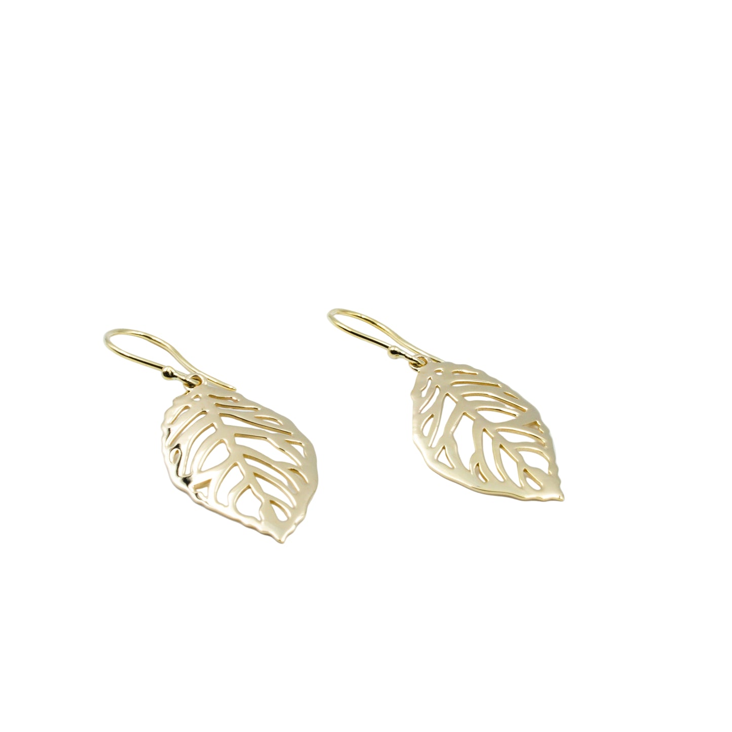 Gold leaf-shaped earrings on a light blue background