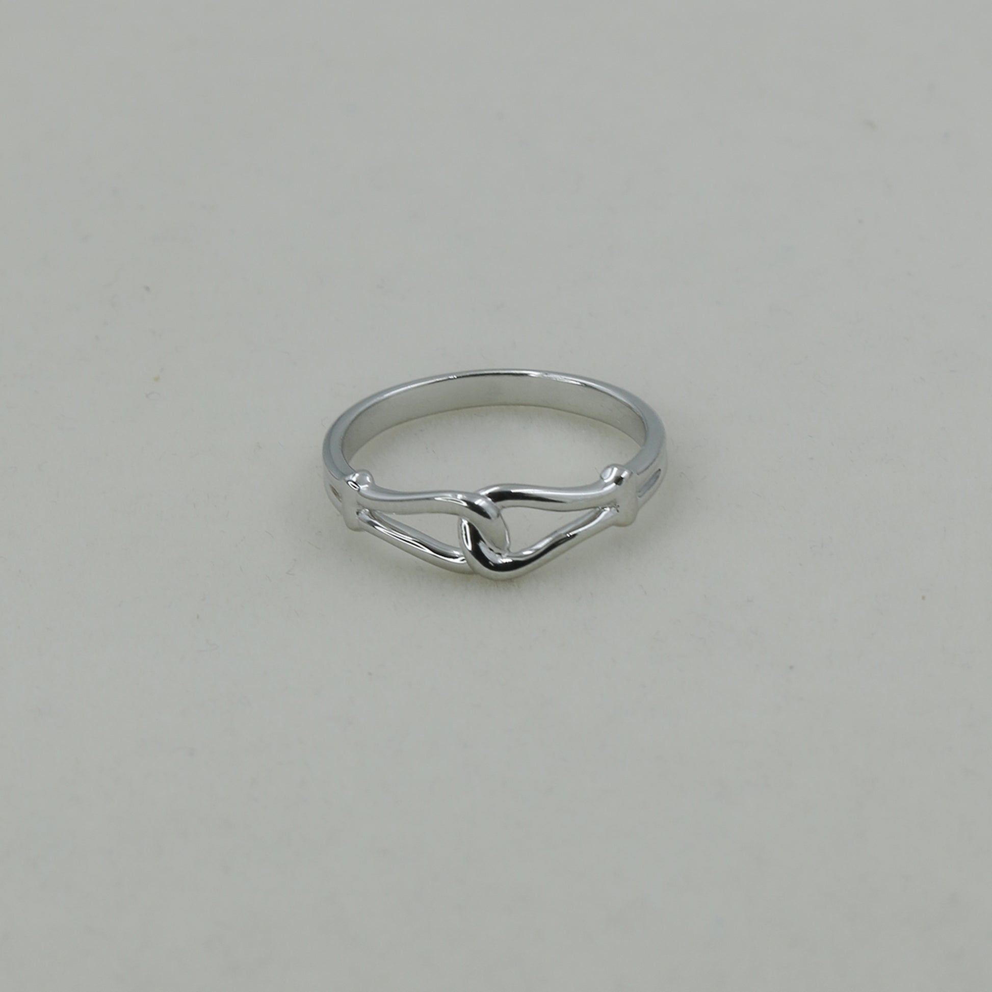 Silver ring on a light gray background