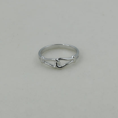 Silver ring on a light gray background