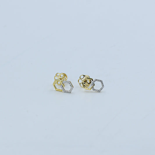 Pair of gold and silver earrings on a light gray background