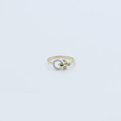 Gold ring with a diamond on a light gray background