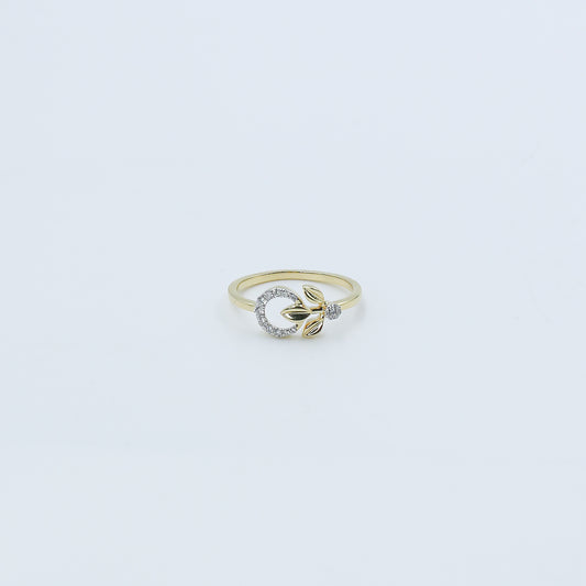 Gold ring with a diamond on a light gray background