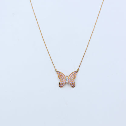 Butterfly-shaped necklace with pink gemstones on a light blue background