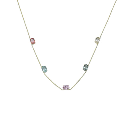 Necklace with small gemstones on a light gray background