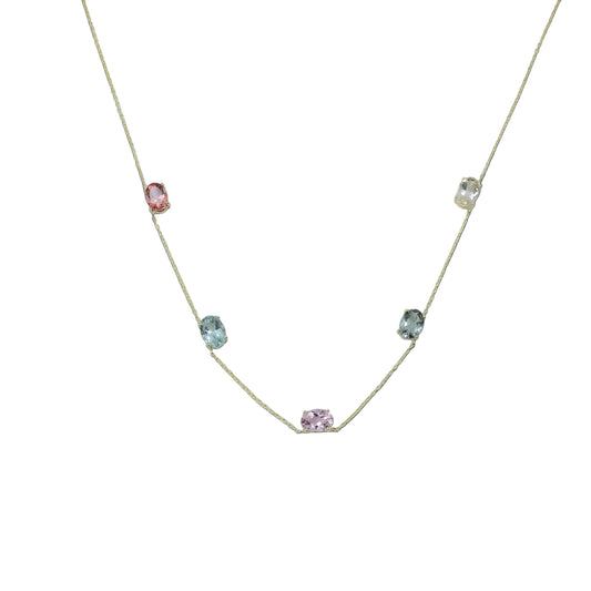 Necklace with small gemstones on a light gray background
