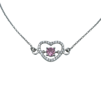 Necklace with a heart-shaped pendant featuring a pink gemstone on a light gray background