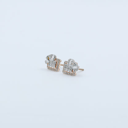 Pair of diamond stud earrings on a light gray background