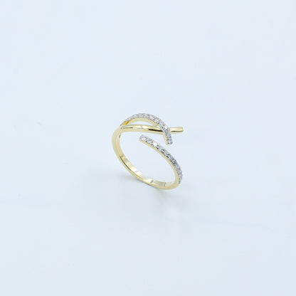 Gold open ring with embedded diamonds on a light gray background
