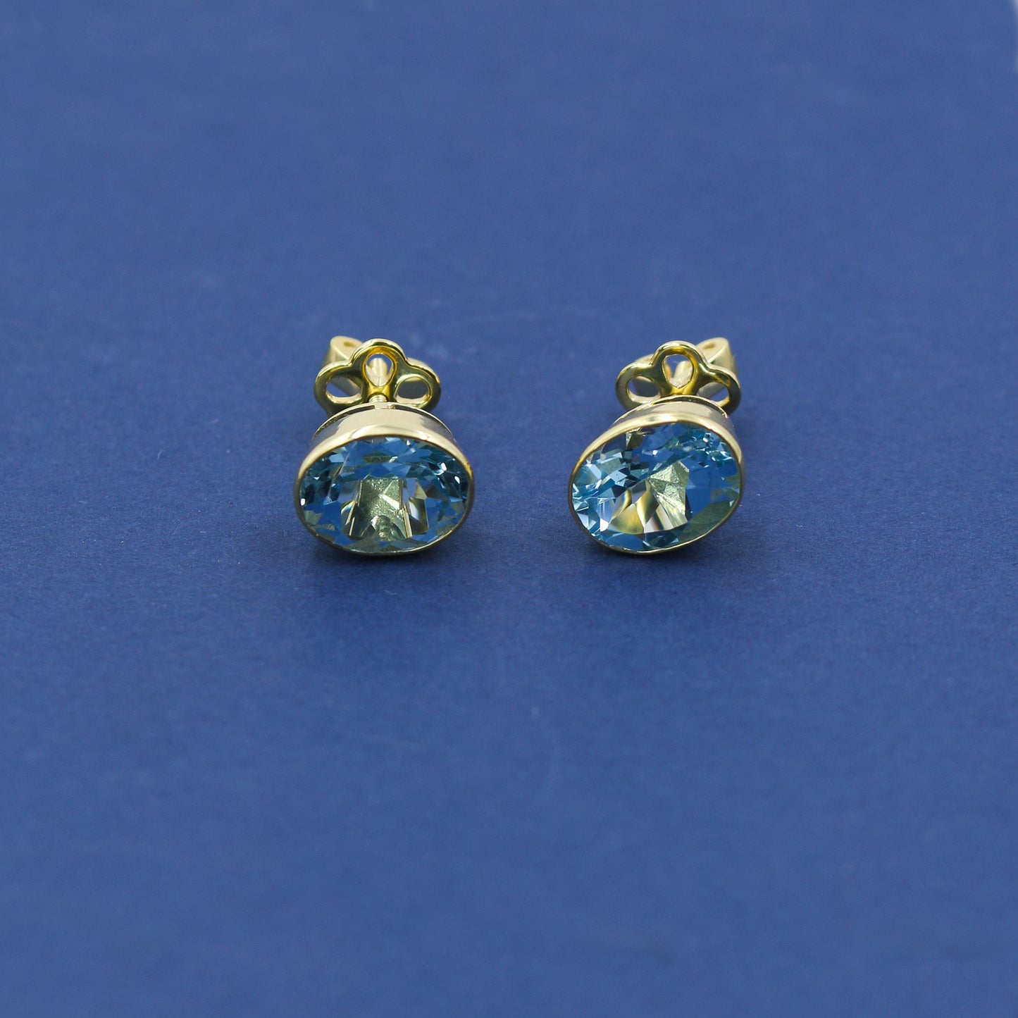 Yellow Gold Blue Topaz Oval Stud Earrings