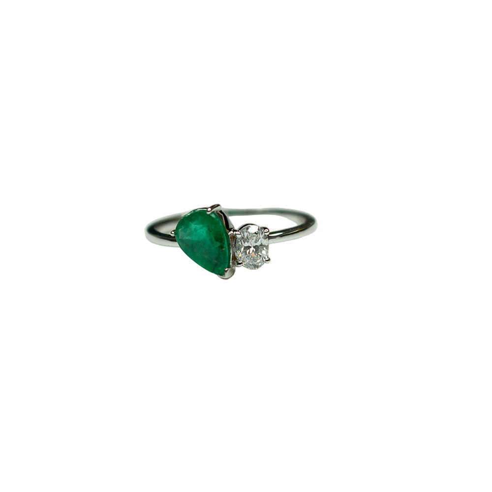 Ring with green gemstone and diamond on a white background